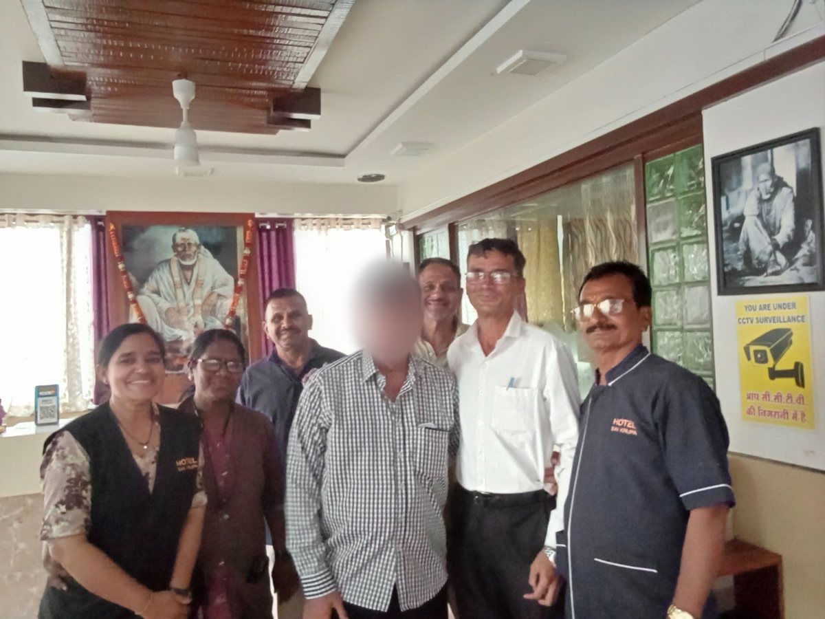 A regular guest with the Hotel Saikrupa team at reception, guest's face blurred